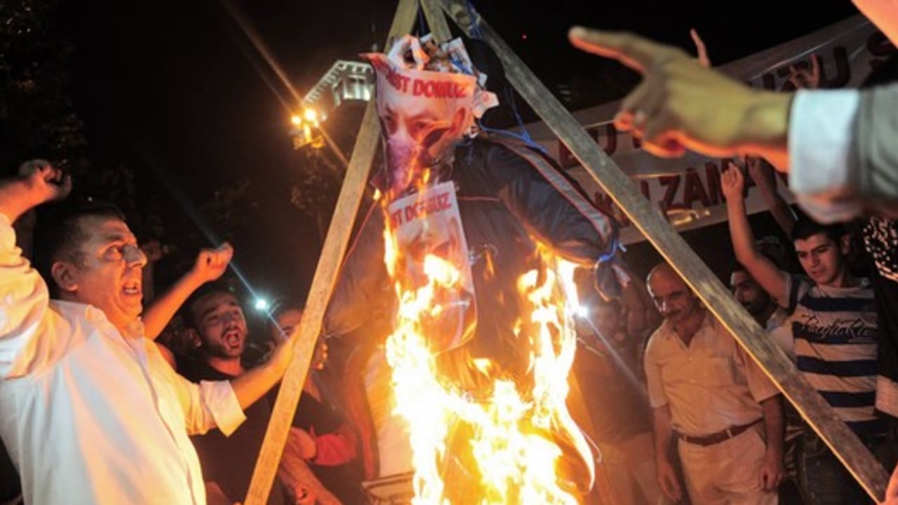 Pro-Palestinian demonstrators set fire to an effigy of Prime Minister Binyamin Netanyahu as they protest against Israel's military action in Gaza, outside the Israeli consulate in Istanbul, early July 19, 2014.