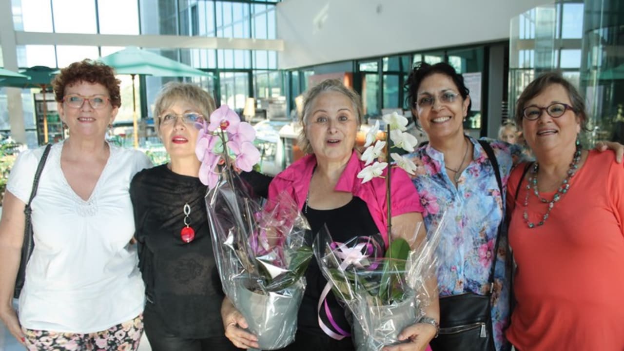 Michal Sharan (center) at the exhibition opening with some of her childhood friends