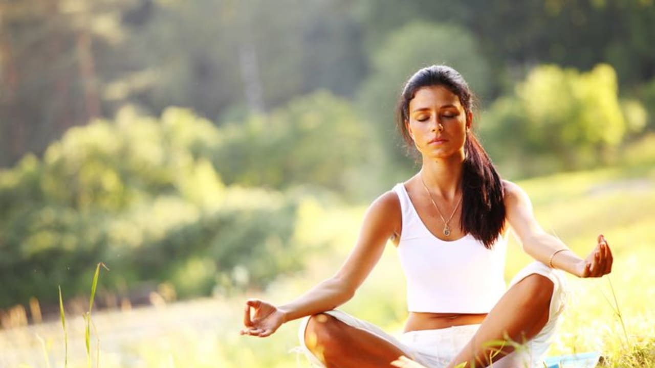 A woman meditating (illustrative photo)