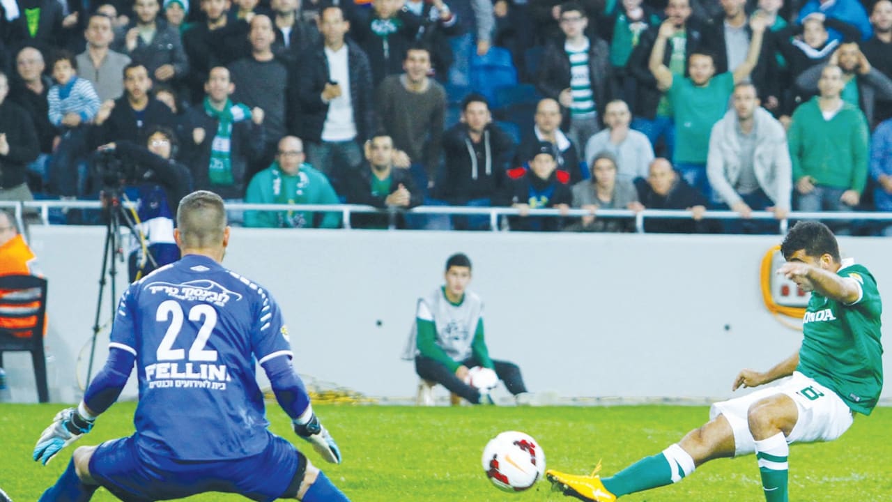 Maccabi Haifa midfielder Hen Ezra firing past Hapoel Tel Aviv goalkeeper Tom Almadon (left)