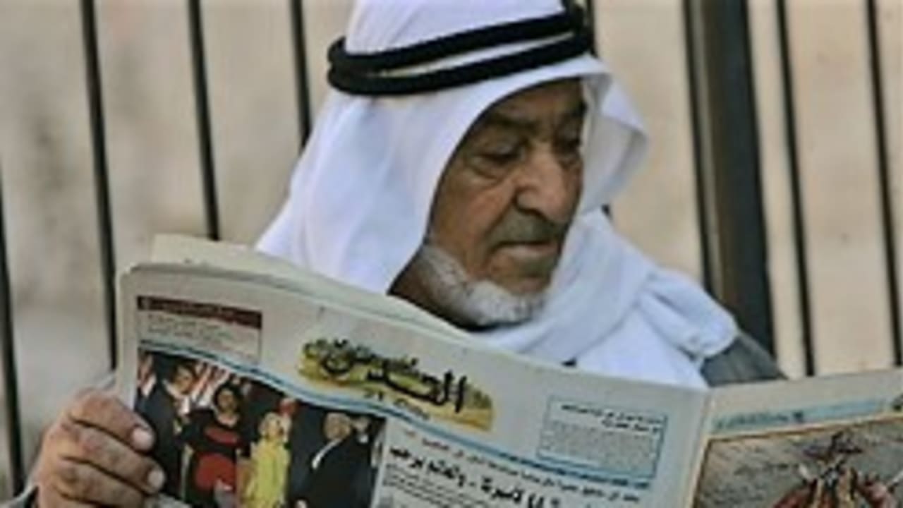 arab man reading paper 248.88 ap