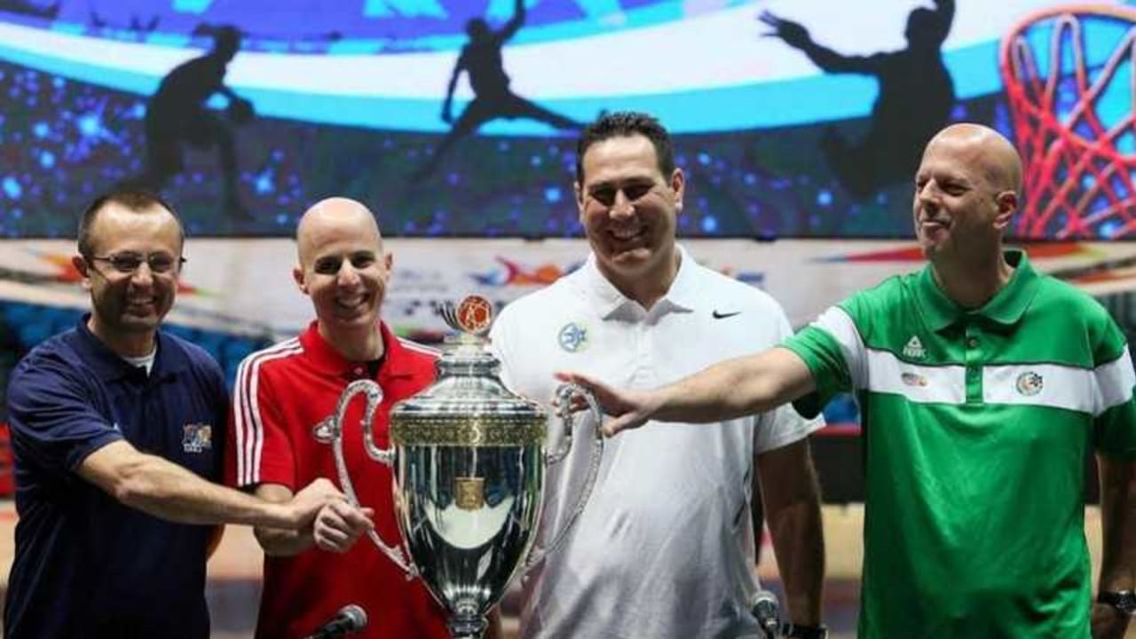 The coaches of Hapoel Eilat (Dan Shamir), Hapoel Jerusalem (Danny Franco), Maccabi Tel Aviv (Guy Goodes) and Maccabi Haifa (Rami Hadar) pose with the State Cup ahead of Monday's semifinals at the Jerusalem Arena.