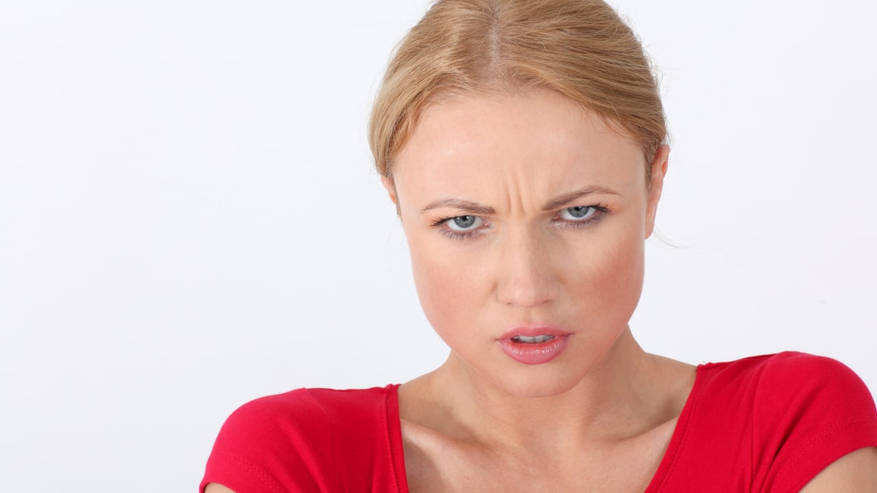 Woman in red shirt with angry look