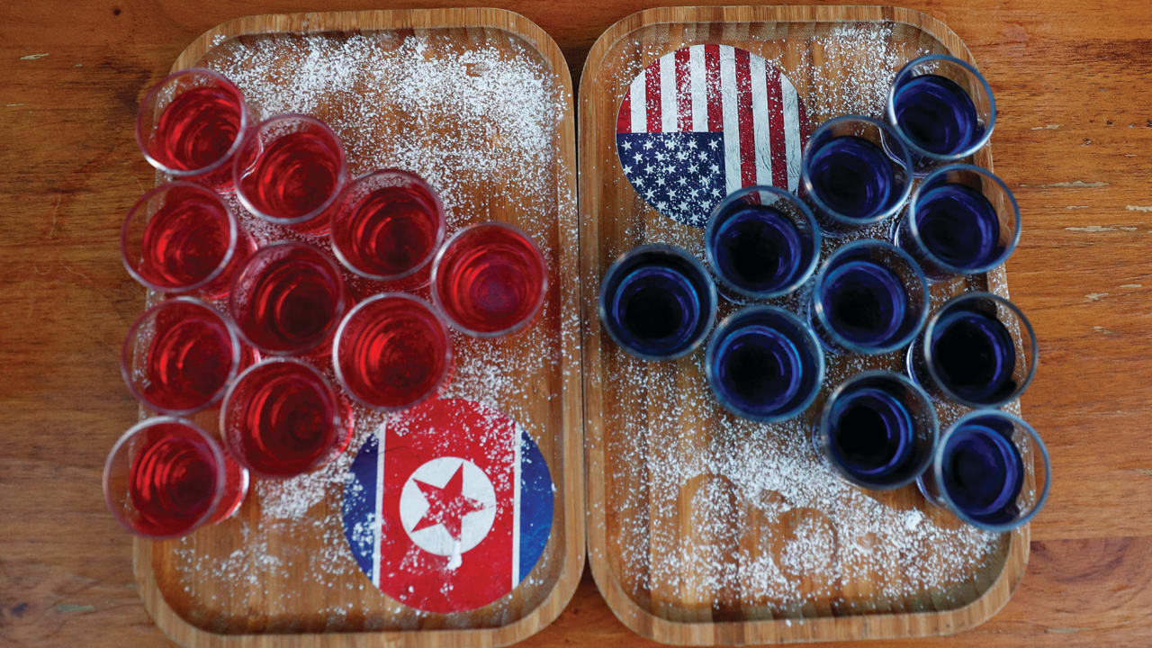 SPECIAL RED AND BLUE shots offered at Escobar bar to mark the summit meeting between Donald Trump and Kim Jong Un are displayed on a table in Singapore last week.