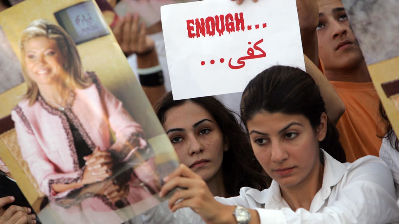 A Lebanese protester carries a poster of prominent anti-Syrian Lebanese television news anchor May Chidiac during a demonstration at Martyrs' Square in Beirut September 29, 2005. Hundreds of protesters condemned the assassination attempt against Chidiac. Chidiac was badly wounded when a bomb explode