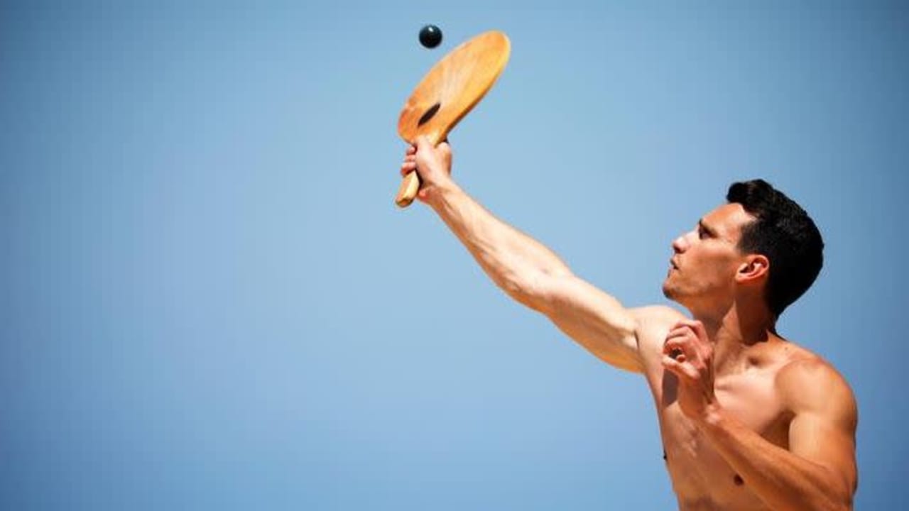 A man plays paddle ball, known in Hebrew as "matkot", a popular Israeli sport, at a beach in Ashkelon, Israel May 4, 2019. Picture taken May 4, 2019. 
