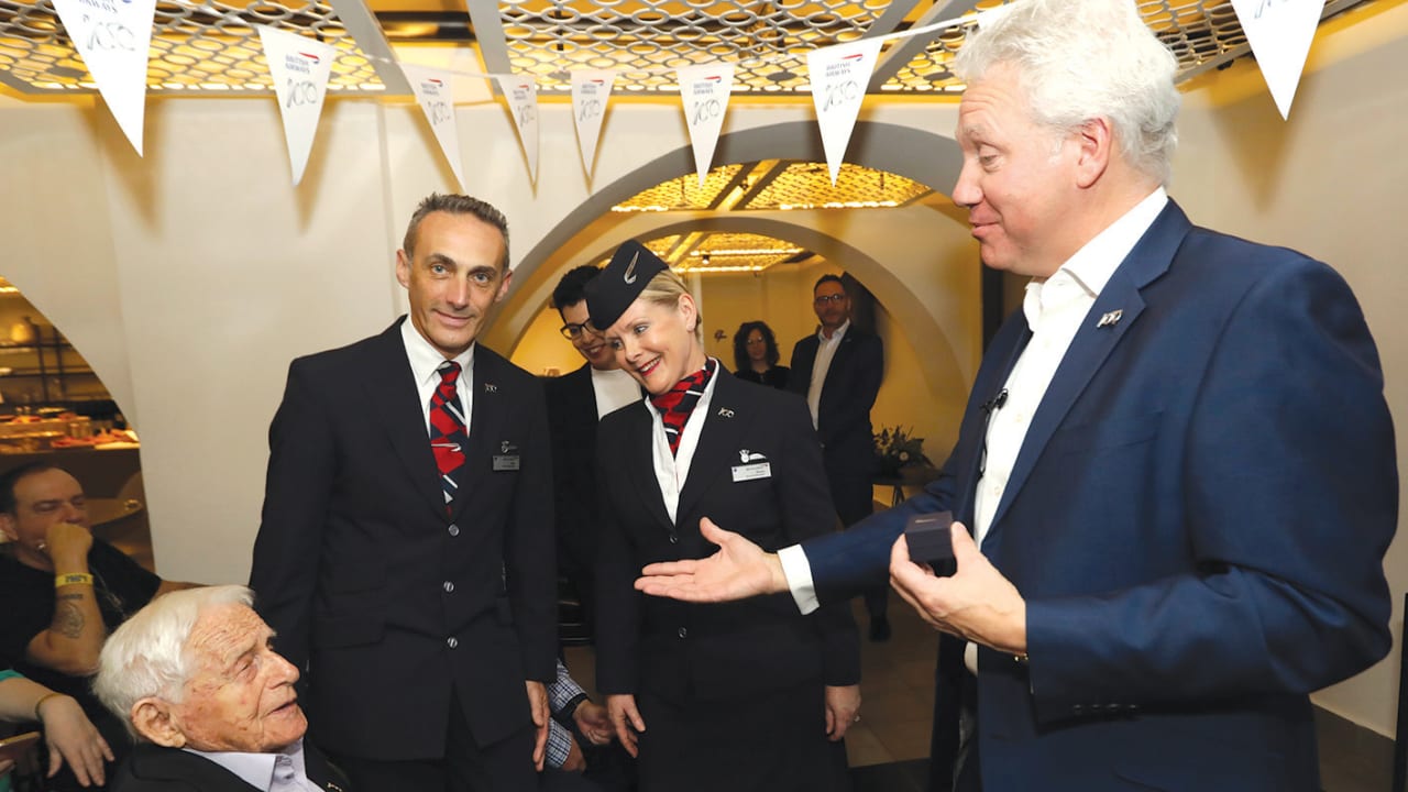 Andrew Brem presents British Airways oldest employee award tp Alex Zielony while BA ambassadors John Folwer and Sheila Beesley look on.