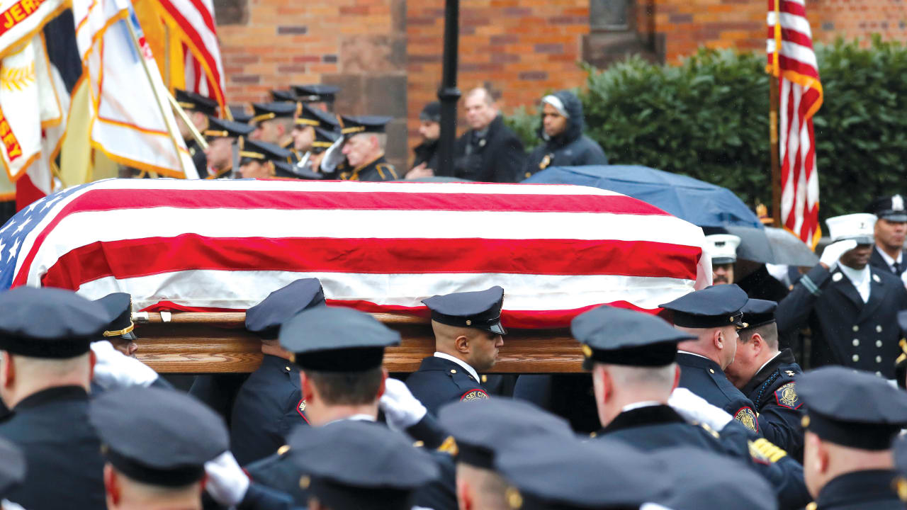 CASKET OF Jersey City Police Detective Joseph Seals carried from St. Aedan’s Church following funeral service in Jersey City.