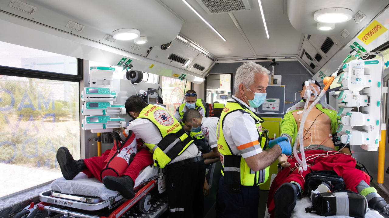 Magen David Adom staff present the new ambulance bus