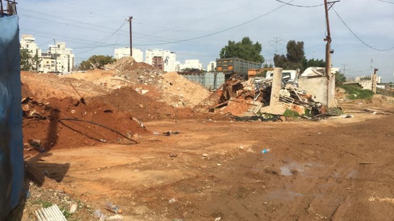 Piles of debris on bare ground at one of the sites. 
