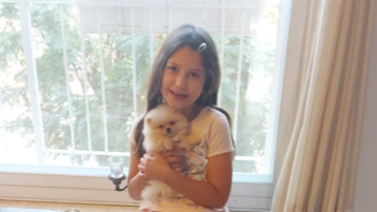 The writer’s granddaughter with Fluffy