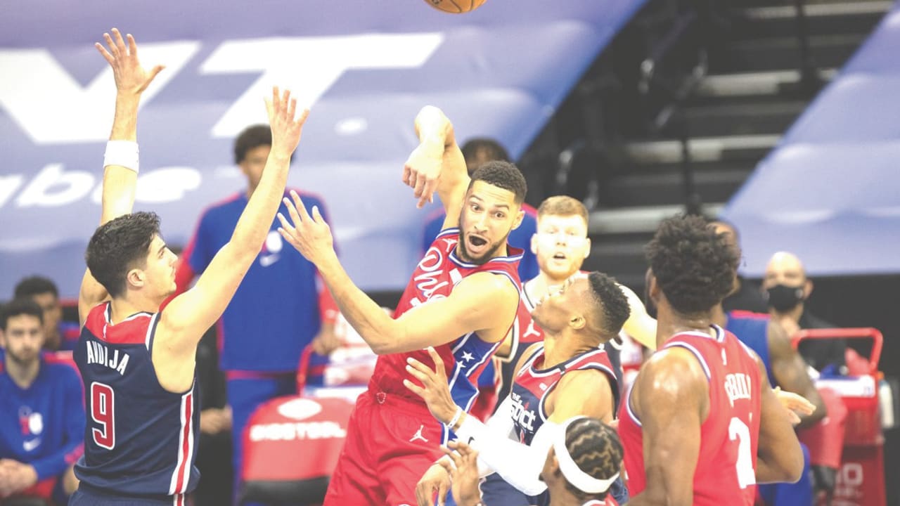 DENI AVDIJA (left) defends against Philadelphia 76ers guard Ben Simmons in his NBA debut for the Washington Wizards late Wednesday night in a game the Sixers won 113-107.