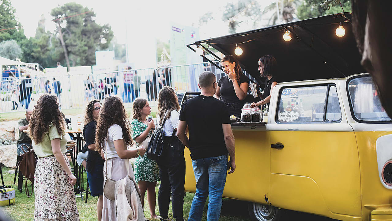 HUNGRY CUSTOMERS queue up for service at the FoodTruck culinary fair in Hinnom Valley Park.