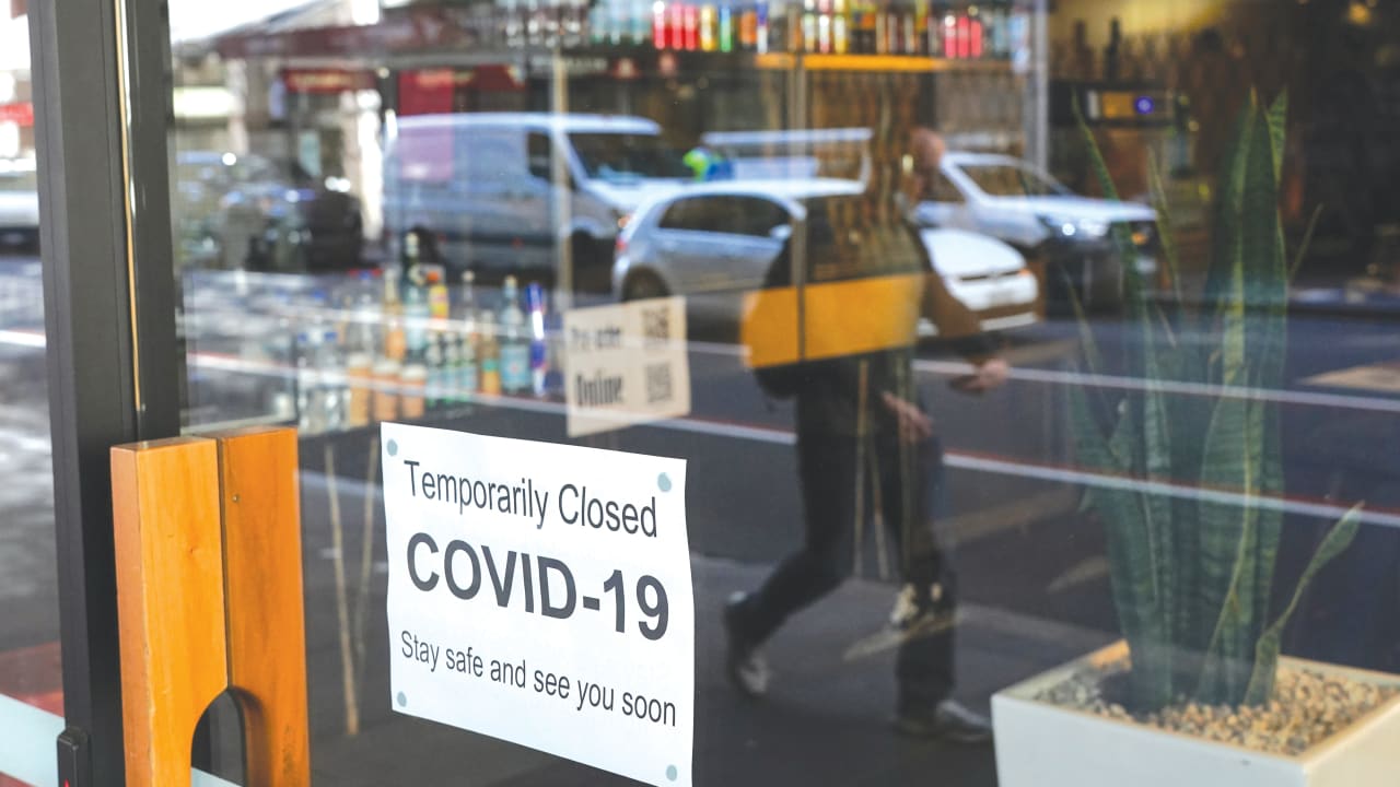  A SIGN IS POSTED in the window of a closed cafe in Sydney last week.