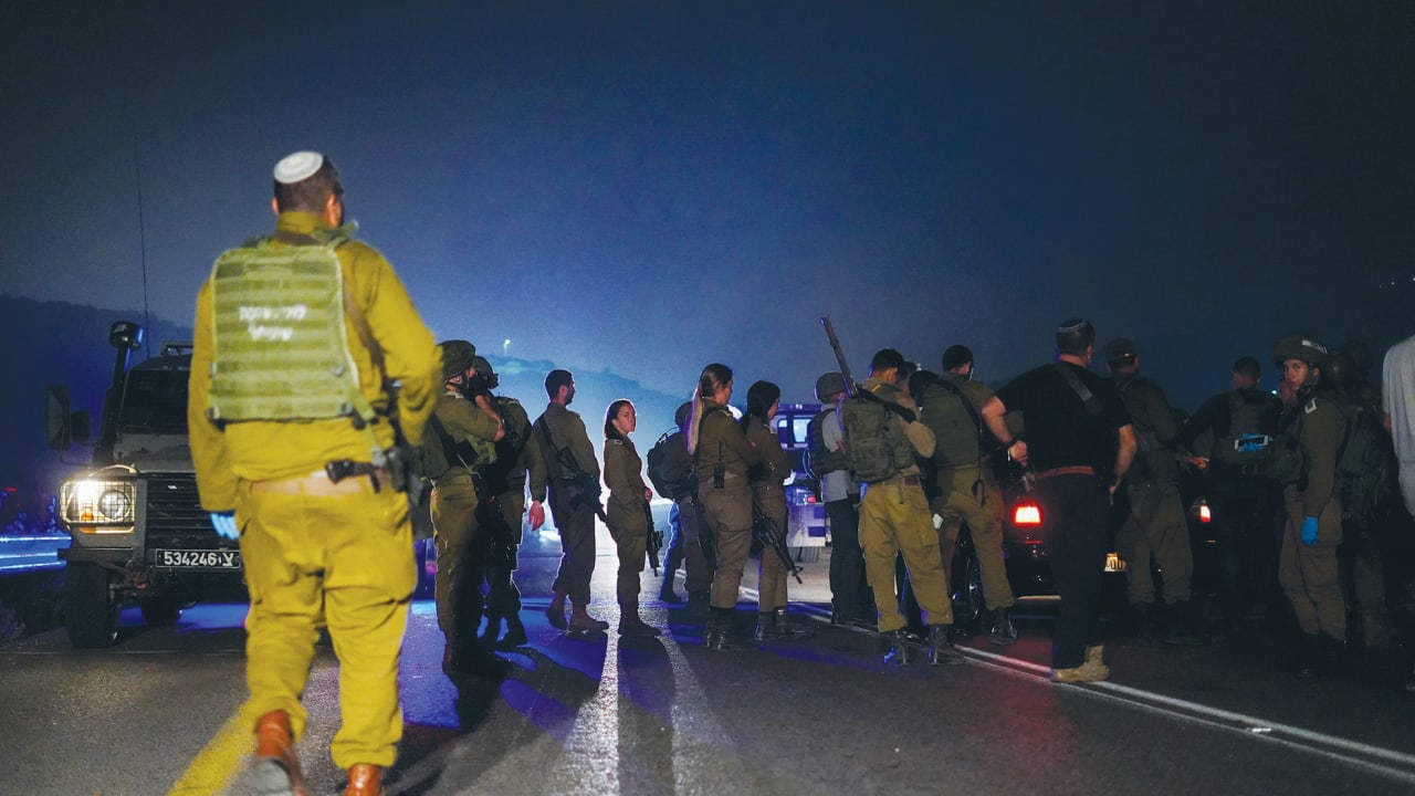  SECURITY FORCES inspect the scene of a shooting attack in Samaria earlier this year.