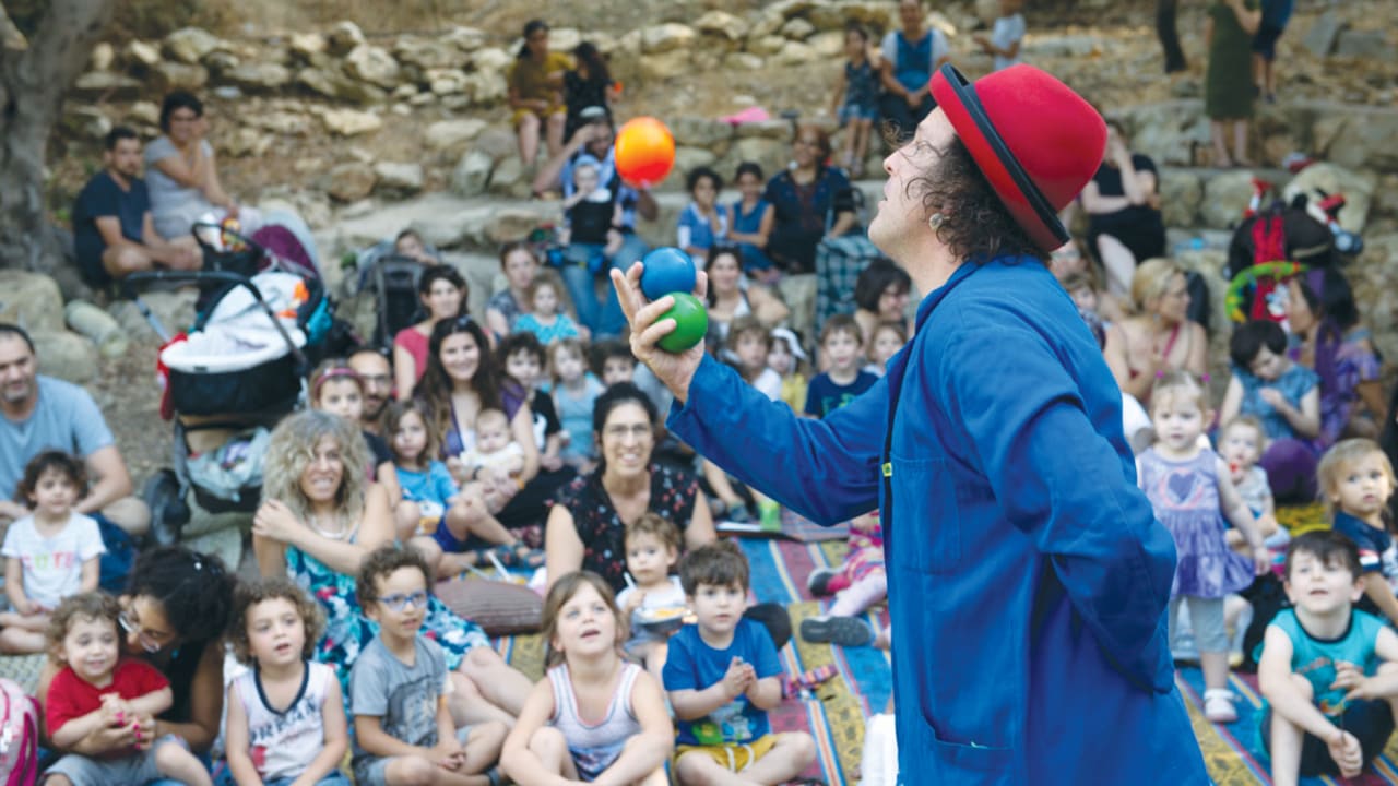  CHILDREN AND ADULTS are entertained in Kiryat Hayovel, as part of the ‘Let’s meet in the park’ project