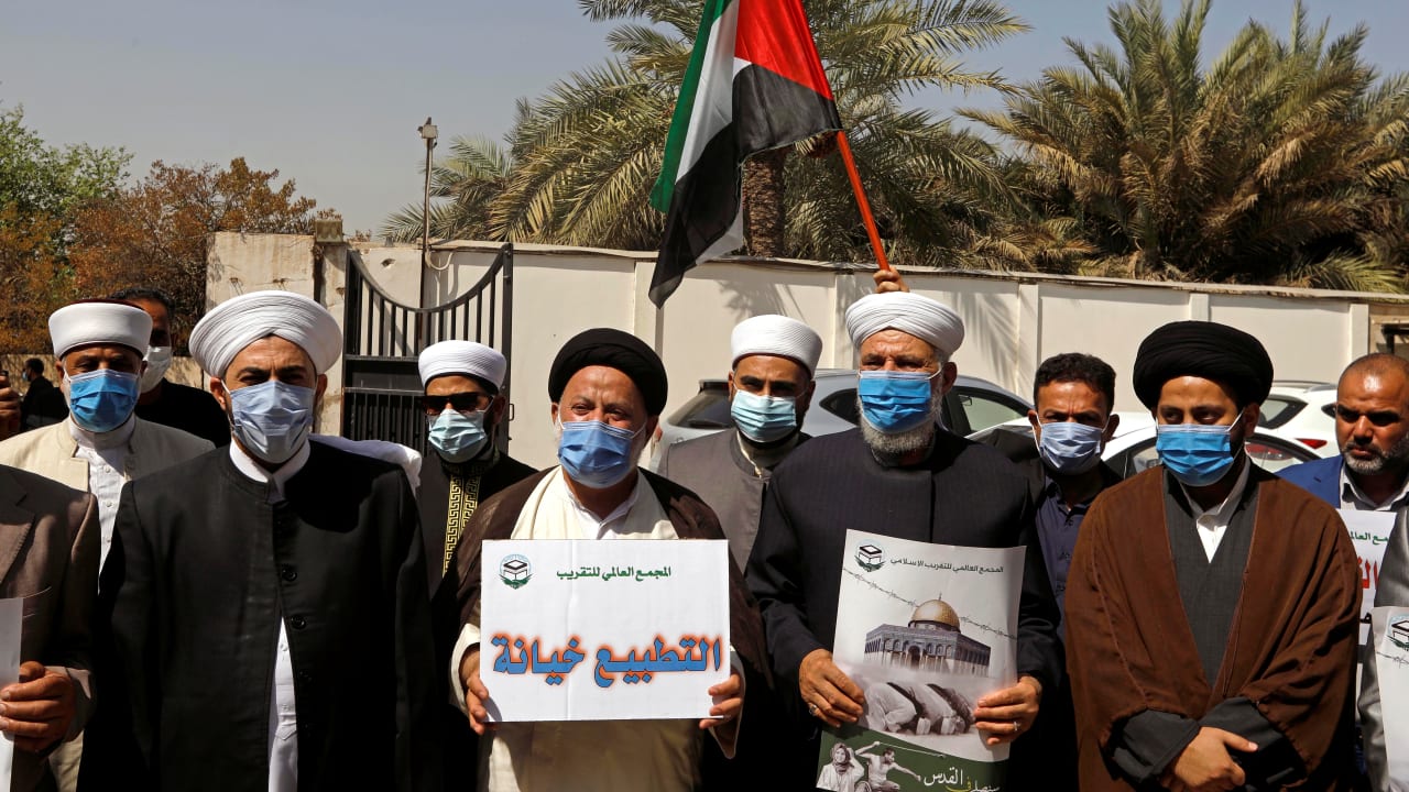 Clerics hold signs and the Palestinian flag during a protest against normalizing ties with Israel, in front of the Palestinian embassy in Baghdad, Iraq September 15, 2020.