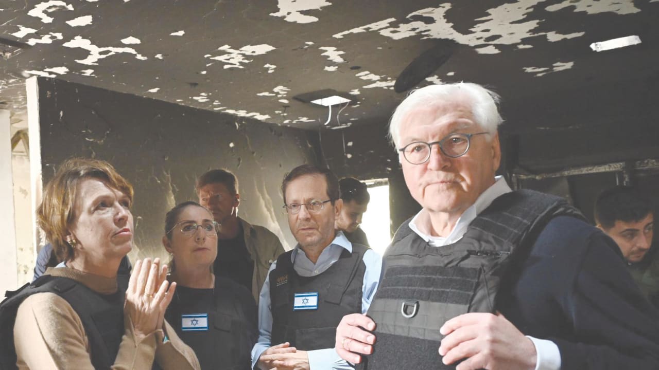  PRESIDENT ISAAC HERZOG and German President Frank-Walter Steinmeier at Kibbutz Be'eri, with survivors of the Hamas massacre.