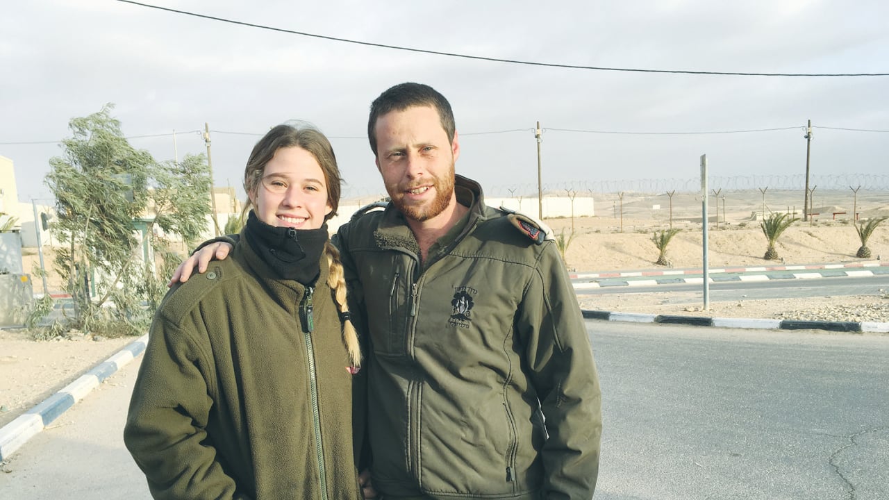  IN HAPPIER times, the writer poses with her cousin, IDF Maj. Moti Shamir, who was killed on October 7, saving others. 
