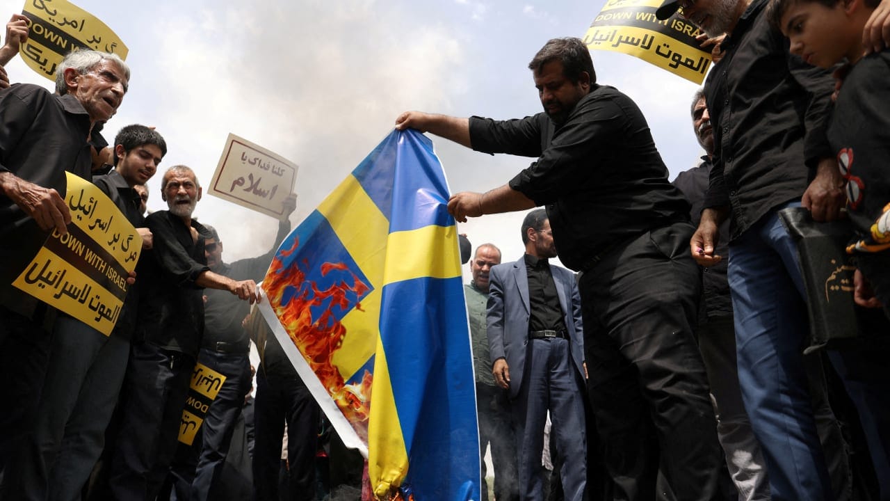  Demonstrators burn the Swedish flag during a protest in Tehran against the insult to the Koran after the Muslim holy book was burned in Stockholm, July 21, 2023. 