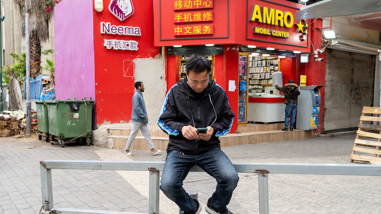 Foreign workers seen around the central bus station in southern Tel Aviv on March 21, 2025.