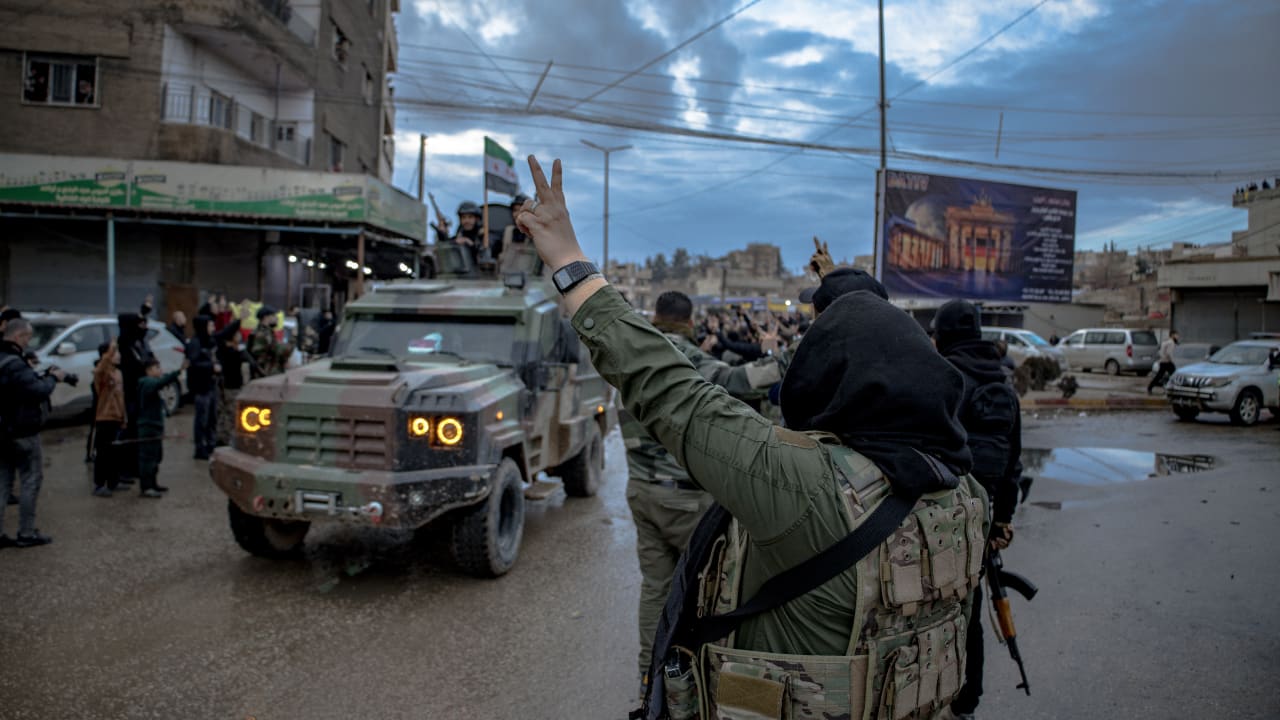  Syrian Public Security Forces drive through a crowd as they enter the Kurdish-majority city of Qamishli in northeastern Syria on February 3, 2026, under an integration deal with Kurdish authorities. 