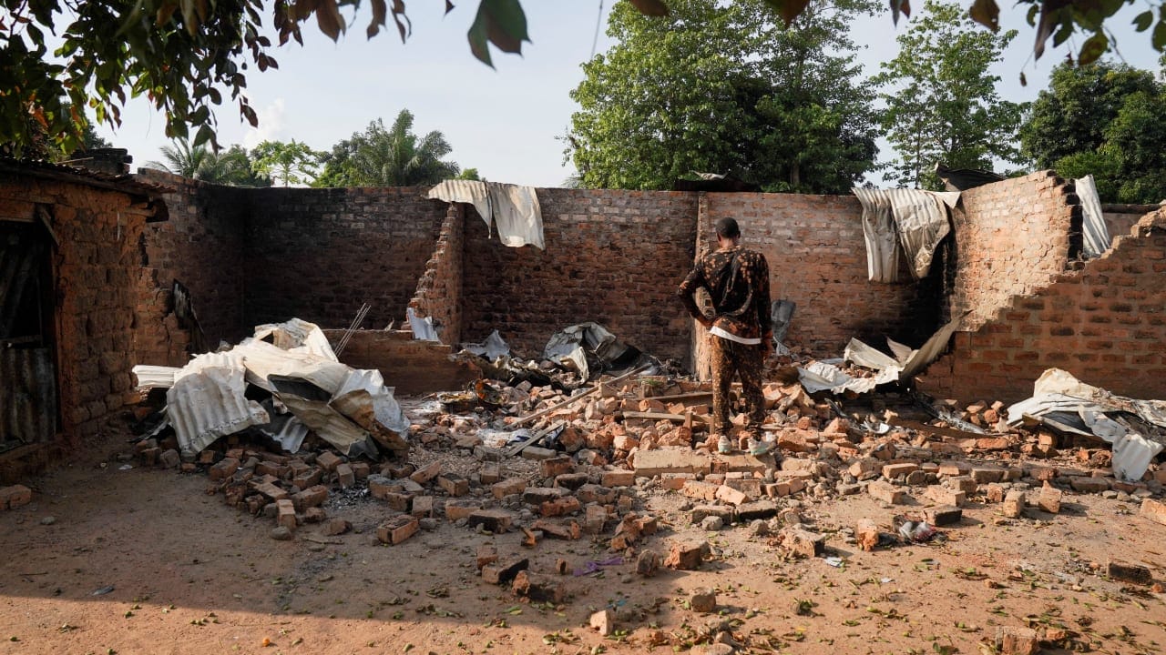  A man stands in front of a damaged and burnt house following a deadly gunmen attack in Yelwata, Benue State, Nigeria, June 16, 2025.