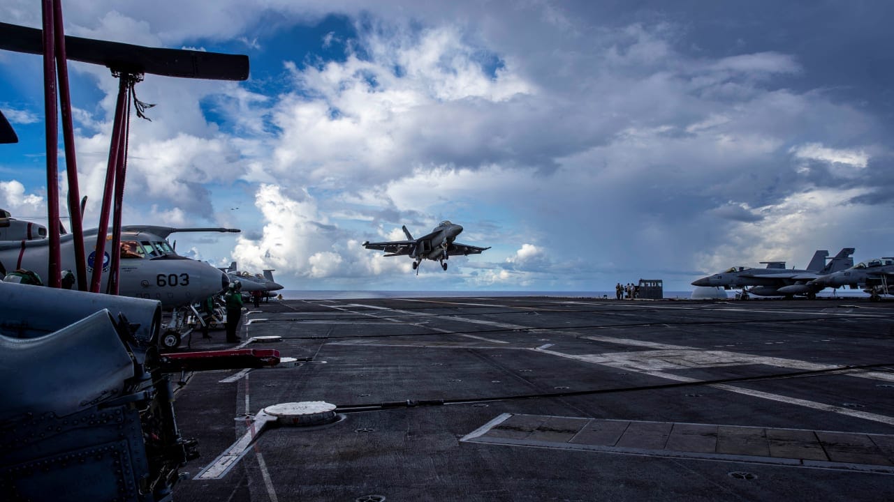 An F/A-18F Super Hornet, assigned to Strike Fighter Squadron (VFA) 41, prepares to make an arrested landing on the flight deck of the US Navy Nimitz-class aircraft carrier USS Abraham Lincoln in the Pacific Ocean August 10, 2024.