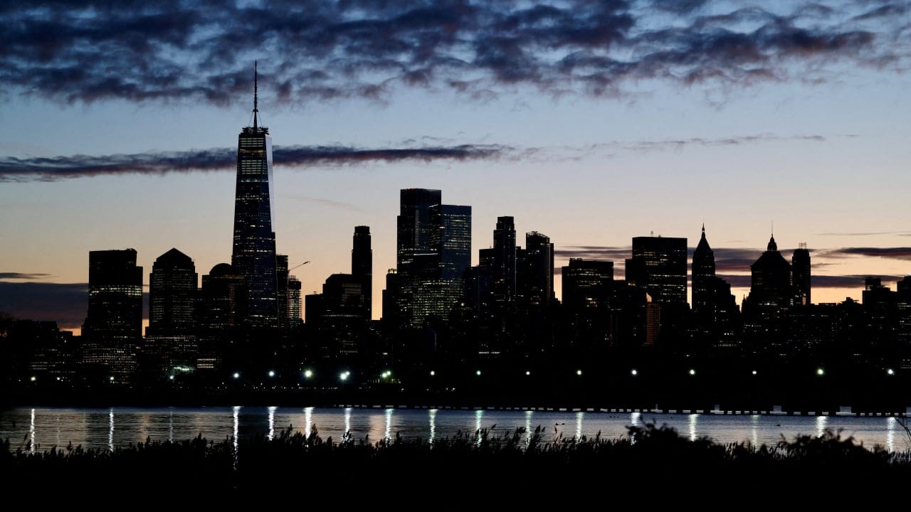 The skyline of Lower Manhattan is seen at dawn from across the Hudson River in New York City, US, October 18, 2025.