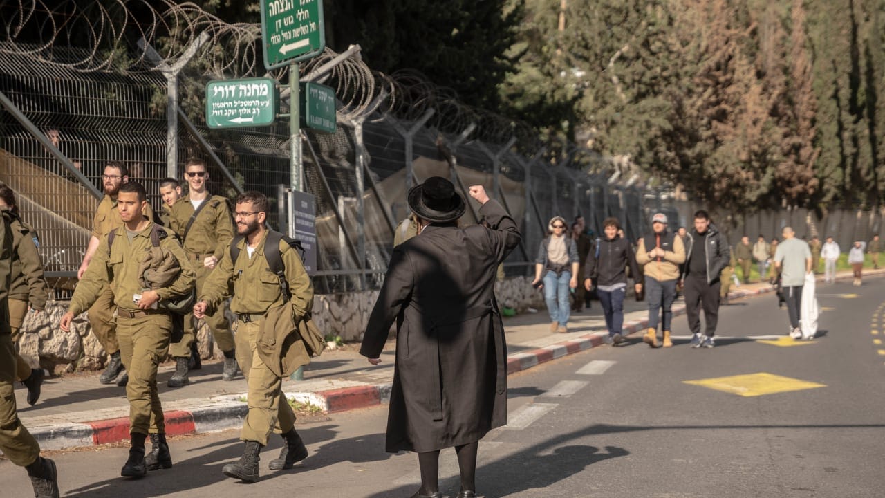 A haredi protestor yells at IDF soldiers during a protest in Tel Aviv on February 4, 2026.