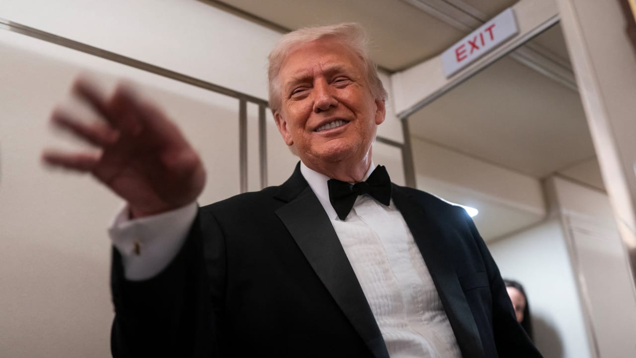 US President Donald Trump waves after speaking with members of the media on board Air Force One en route to Palm Beach, Florida, US, January 31, 2026.