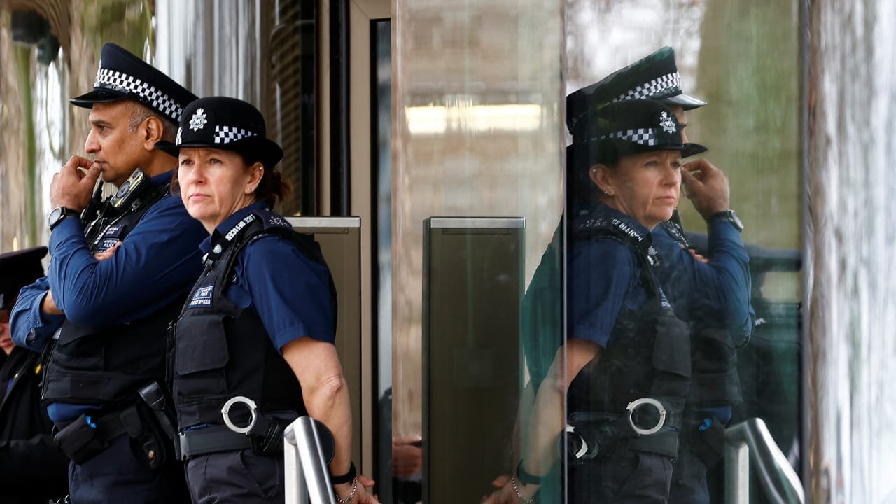 Police officers stand outside New Scotland Yard, the headquarters of the Metropolitan Police, in London, Britain March 21, 2023. 