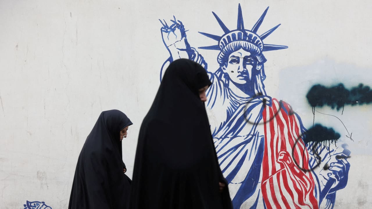 Women walk past an anti-US mural on a street in Tehran, Iran, February 5, 2026