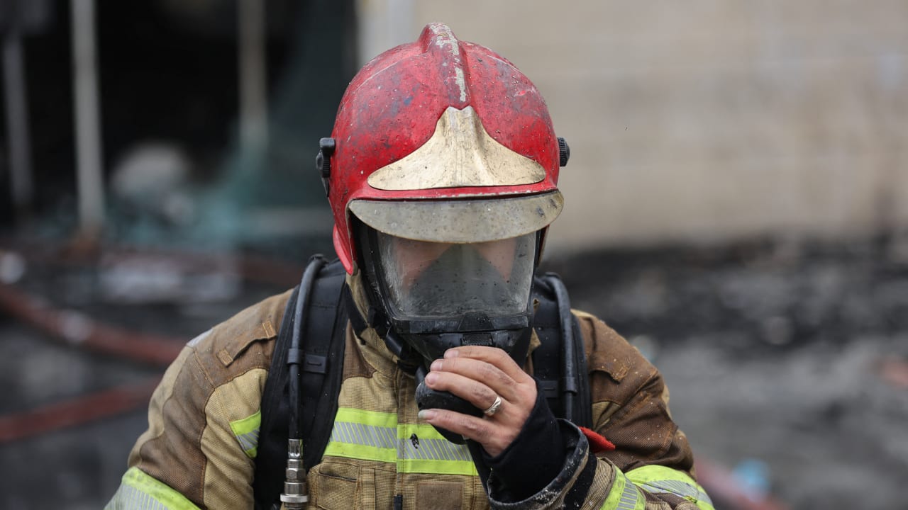 A firefighter works at the scene of a fire at Janat Abad Market in Tehran, Iran, February 3, 2026.