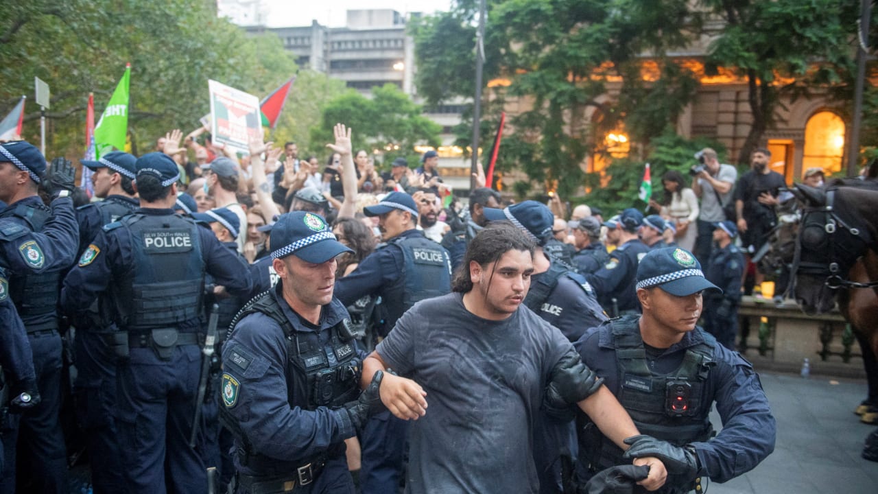 Police officers remove demonstrators gathered at Town Hall Square to protest against President Isaac Herzog's state visit to Australia, in Sydney, Australia, February 9, 2026