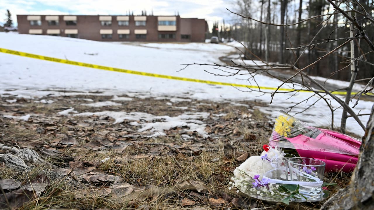Flowers lie on the ground near the site of a mass shooting at a high school, in the town of Tumber Ridge, British Columbia, Canada February 11, 2026.