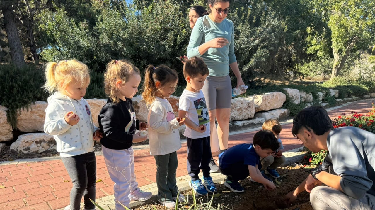 Dutch volunteers plant tulips with children in November, in the agricultural community of Mivtachim along the Gaza border.