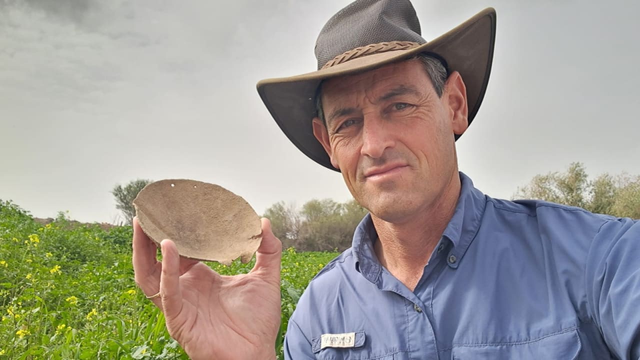 Archaeologist Achiya Cohen-Tavor holding bronze scale pan found in the ancient Jewish settlement of Sussiya, February 19, 2026.