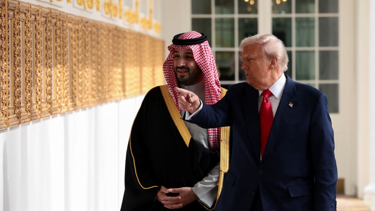 US President Donald Trump and Saudi Crown Prince and Prime Minister Mohammed bin Salman look at portraits at the "Presidential Walk of Fame" in the Colonnade at the White House in Washington, DC, November 18, 2025.