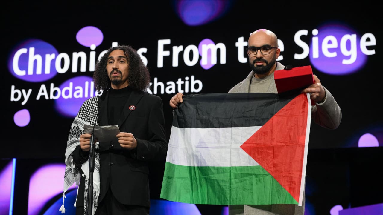 Palestinian director Abdallah Alkhatib (L) and Algerian producer Taqiyeddine Issaad accept the GWFF Best Feature Film Debut Award for "Chronicles From the Siege" during the Award Ceremony of the 76th Berlinale on February 21, 2026.