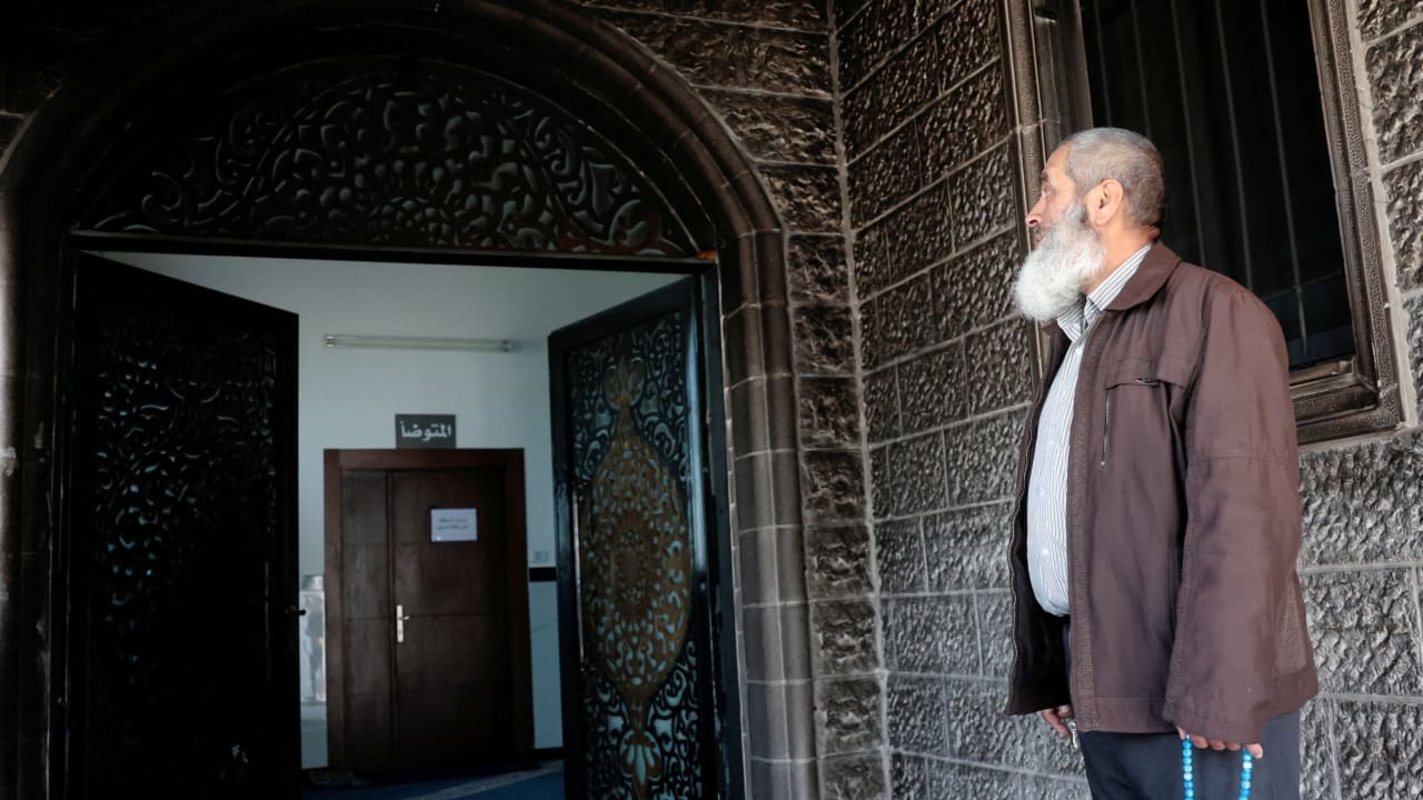 A Palestinian man, holding Misbaha prayer beads, inspects the debris at a mosque, which Palestinians say was damaged by Israeli settlers, in West Bank village of Surra, near Nablus in the Israeli-occupied West Bank, February 23, 2026.