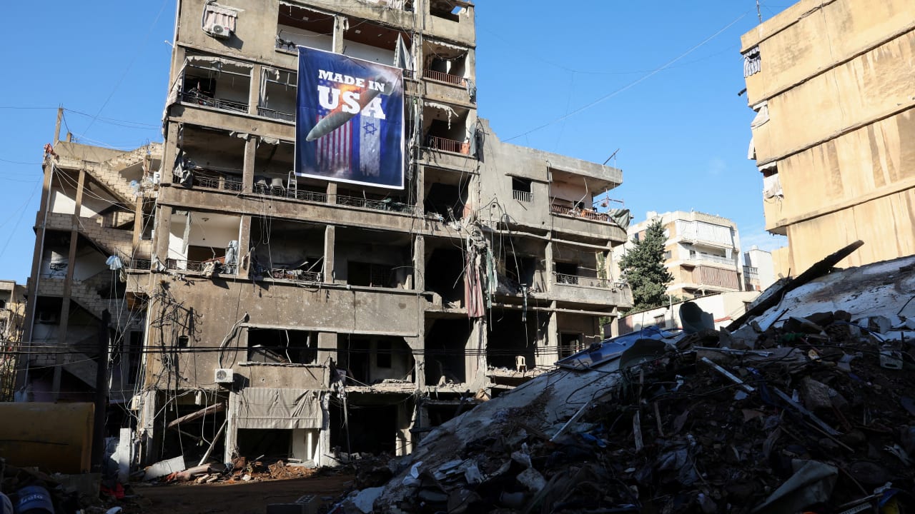 A banner that reads 'Made in USA' hangs on a damaged building in the Chiyah district of Beirut's southern suburbs, Lebanon, November 28, 2024