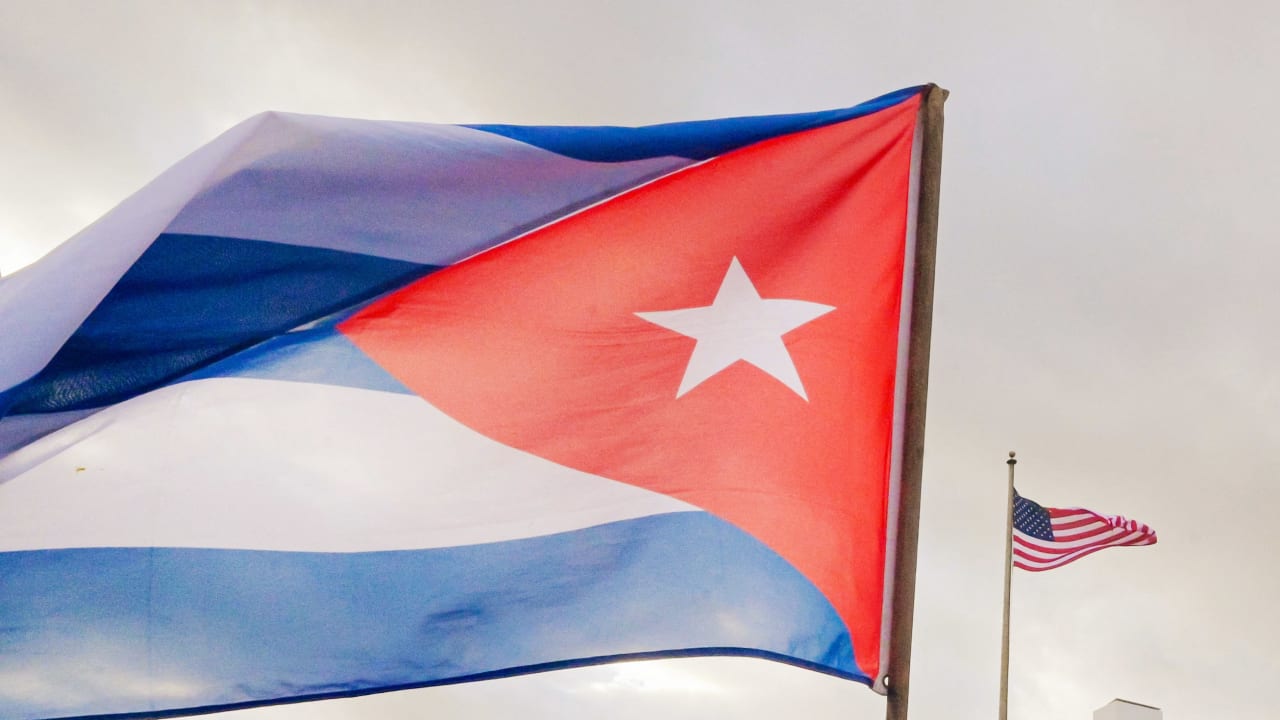 A Cuban soldier waves a national flag as he takes part in the "Anti-Imperialist" protest in front of the US Embassy against the US incursion in Venezuela, where 32 Cuban soldiers lost their lives, in Havana on January 16, 2026.