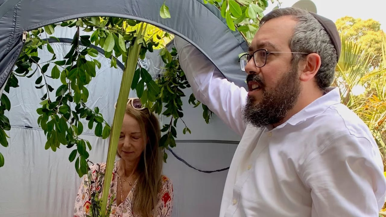 Nikki Goldstein and Rabbi Eli Schlanger celebrate Sukkot.