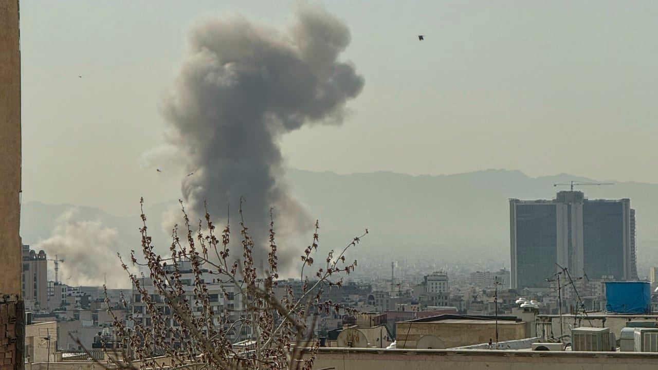 A plume of smoke rises over Tehran after a reported explosion on February 28, 2026, after Israel said it carried out a "preemptive strike" on Iran as sirens sounded in Jerusalem and phone alerts warned of an "extremely serious" threat.