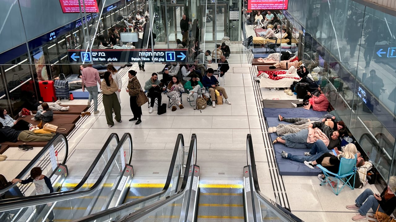People take cover from incoming missiles fired from Iranת at an undergoing train station in Tel Aviv, February 28. 2026.