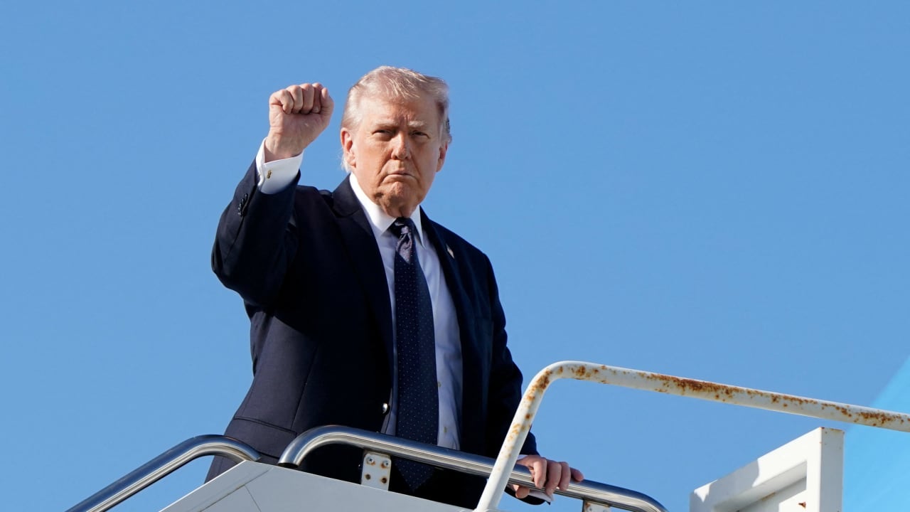 US President Donald Trump gestures as he boards Air Force One at Palm Beach International Airport in West Palm Beach, Florida, US, March 1, 2026.