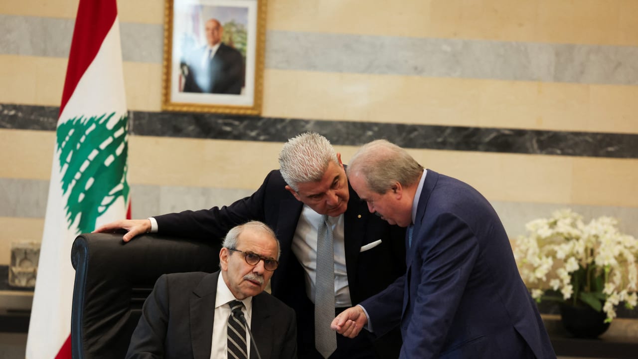 Lebanese Prime Minister Nawaf Salam speaks with Finance Minister Yassine Jaber and Lebanese Industry Minister Joe Issa el-Khoury during a cabinet meeting in Beirut, Lebanon, December 23, 2025.