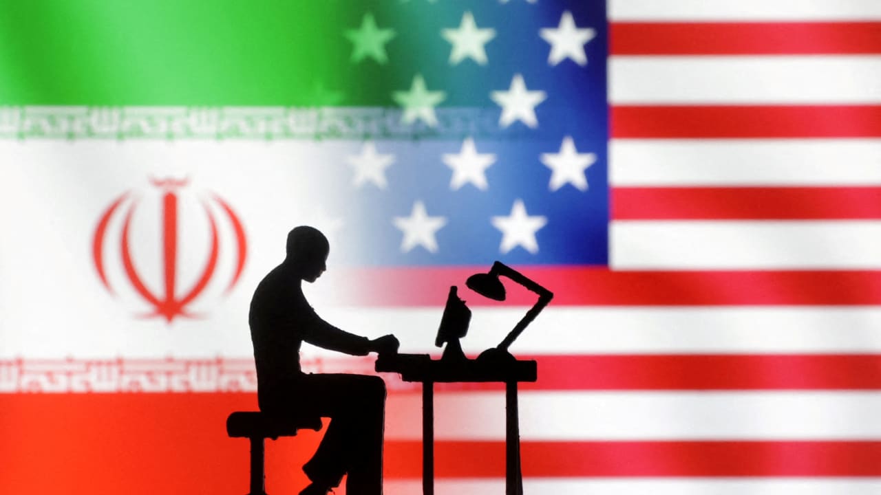 FILE PHOTO: Figurines with computers are seen in front of US and Iran flags in this illustration taken, September 10, 2022. 