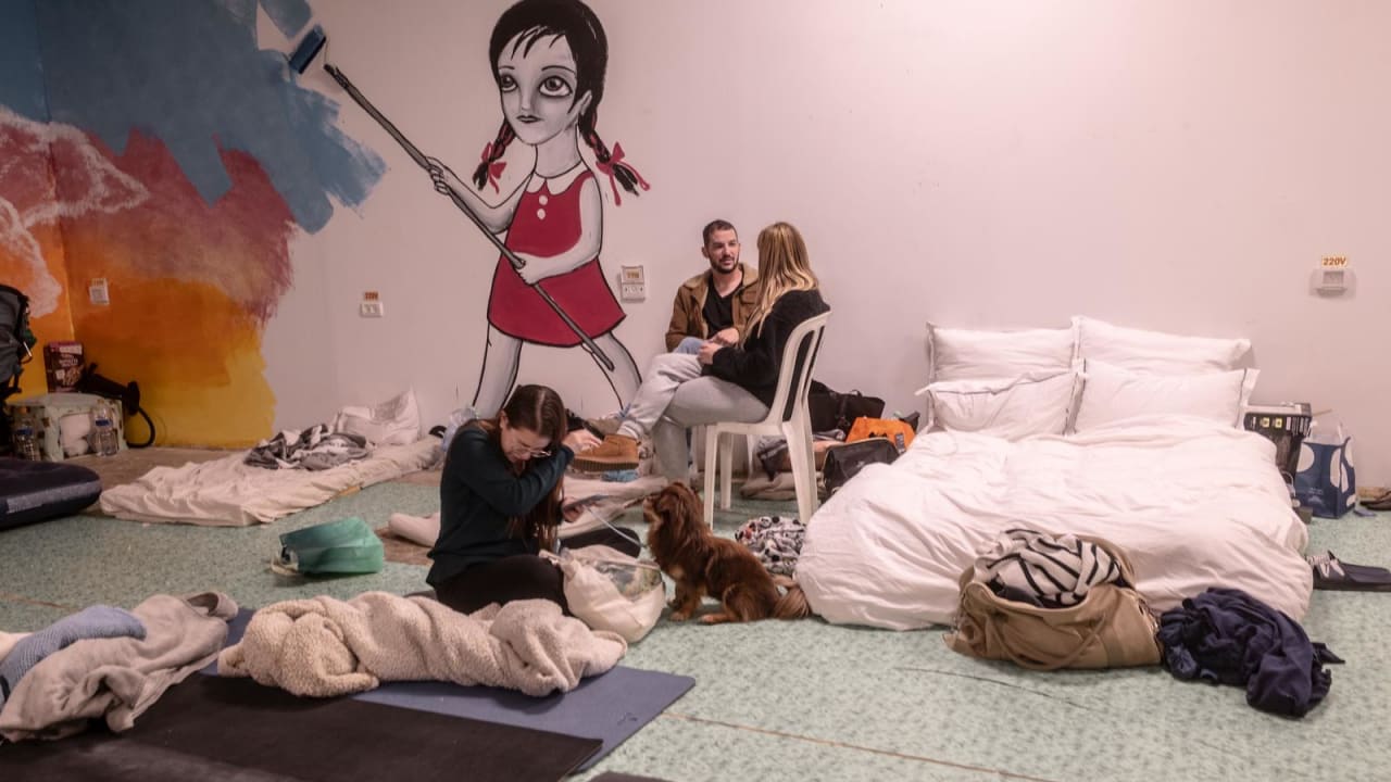 People gather in a public shelter in Tel Aviv amid rocket fire from Tel Aviv. 